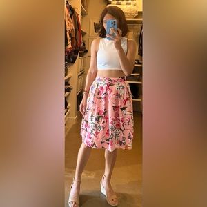 A line, knee-length, silk blend pink floral skirt with a ruched back & lining.